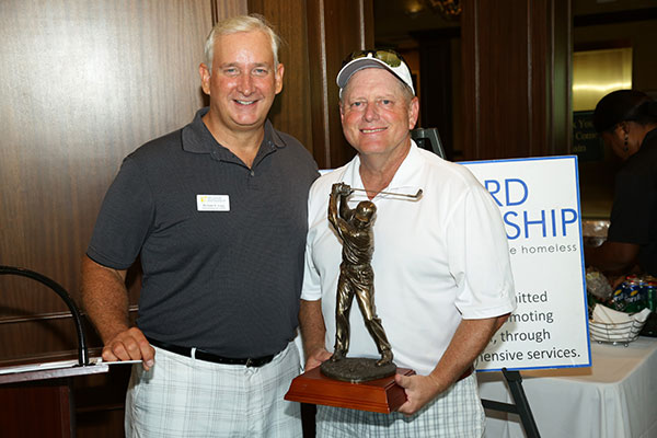 Michael Long, Chief Development Officer of the Broward Partnership presenting Michael Keeby, Regional President, Brown & Brown of Florida and board member of the Broward Partnership with the trophy for the Company Raising the Most Funds for the 8th Annual Broward Partnership Golf Challenge. 