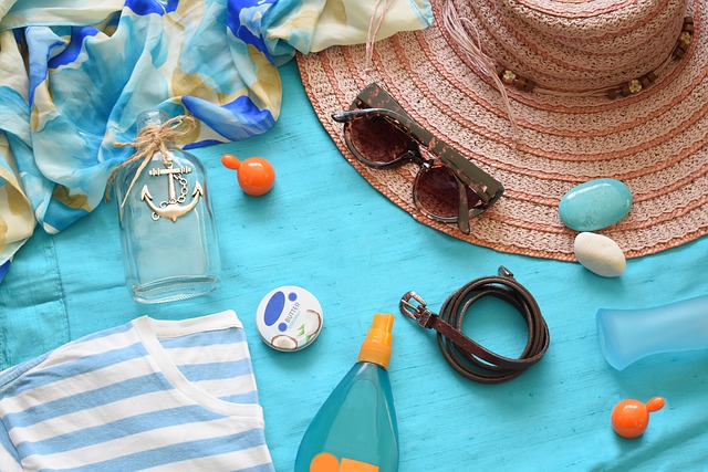 Beach items on a towel, including sunscreen.