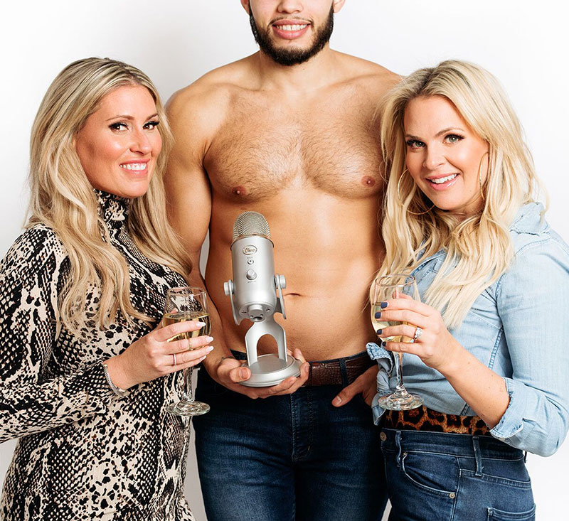 Two women and a topless man.