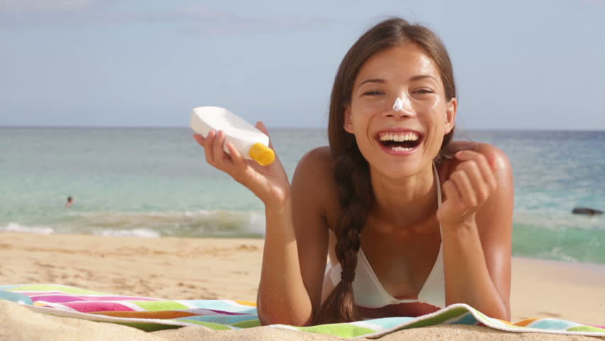 Girl Applying sunscreen on her body