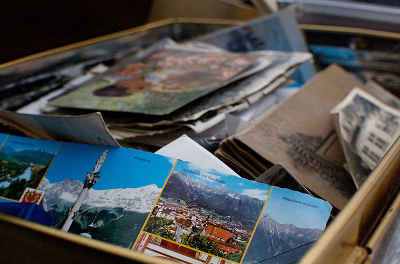 a box filled with books, postcards, and other items.