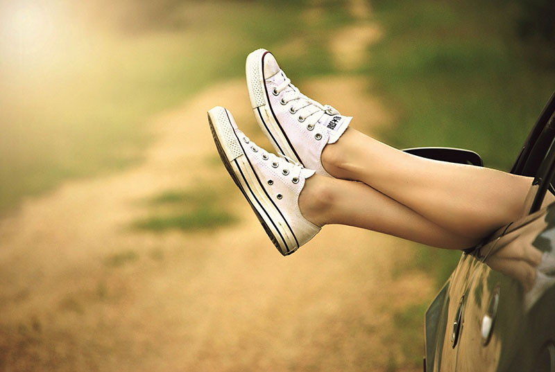 a woman's feet coming out of the car, showing that she's relaxed