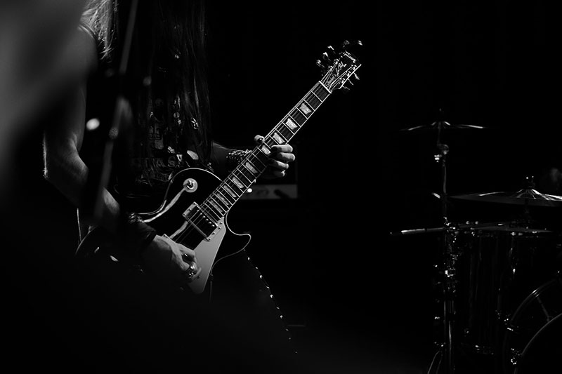 A rock & roll guitarist shredding live.