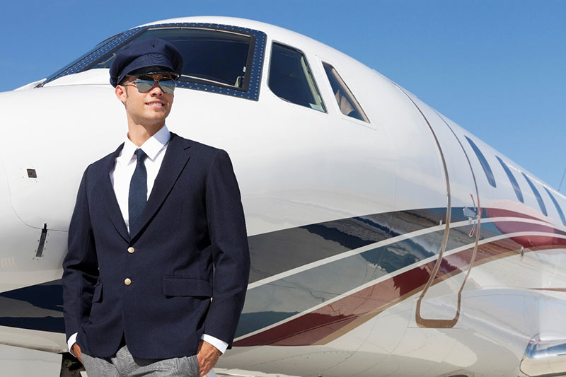Young Pilot standing by a private airplane