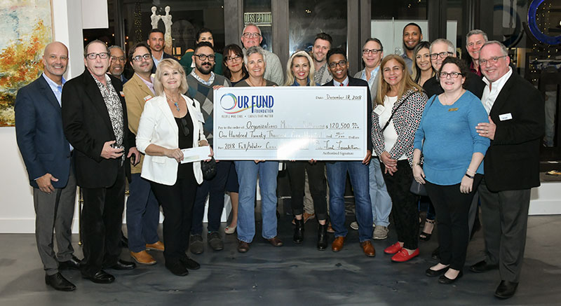 Grantees with check during Our Fund Foundation Fall 2018