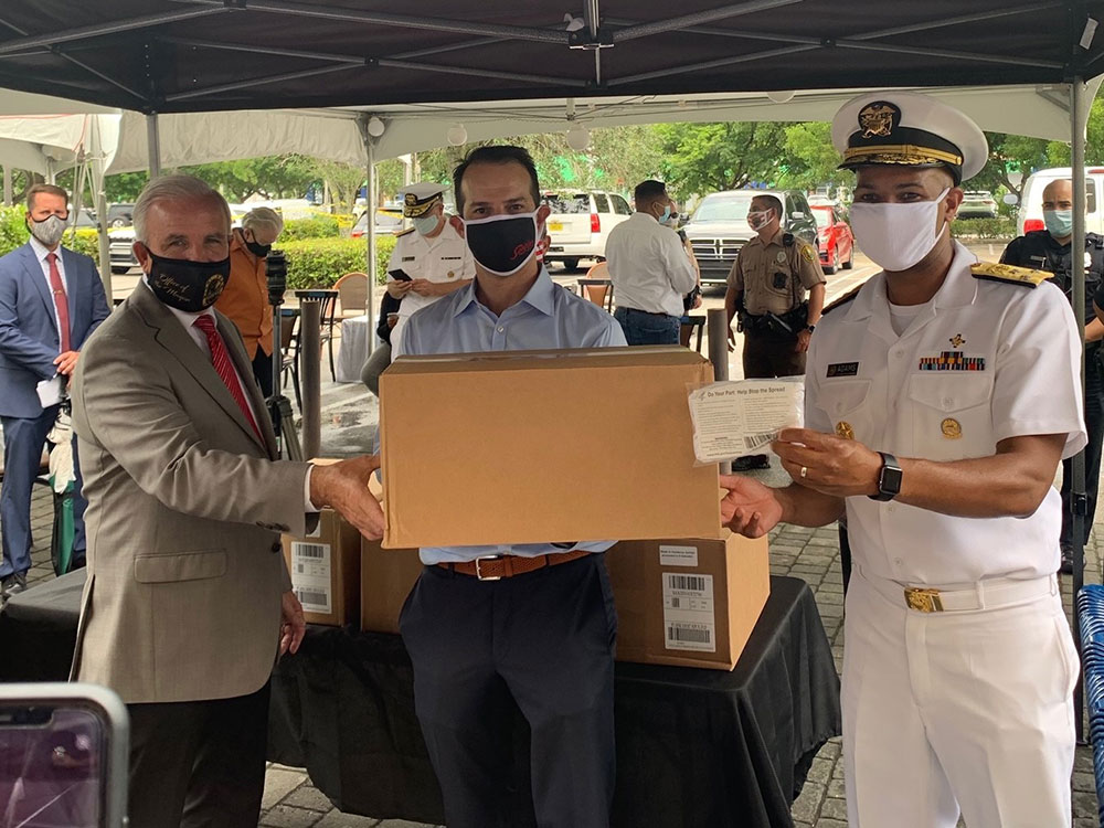 L-R: Miami-Dade County Mayor Carlos Gimenez, Sergio’s President and FRLA Executive Board Member Carlos Gazitua, and U.S. Surgeon General Vice Admiral Jerome Adams prepare to distribute donated masks to South Florida restaurant and hotel employees