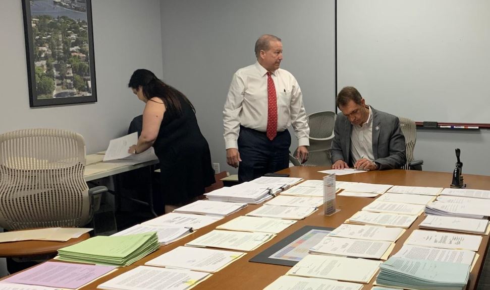 Mayor of Fort Lauderdale with Documents on a table