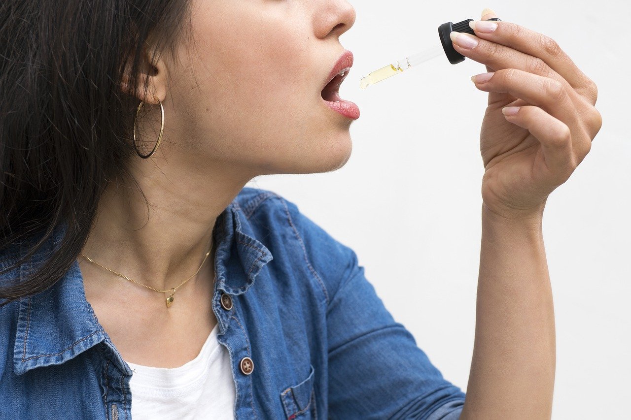 a woman taking cbd oil