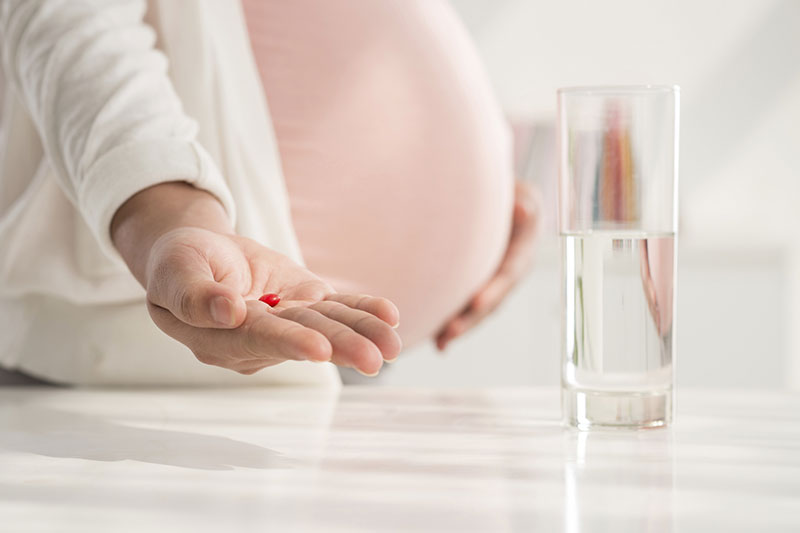 Woman taking prenatal vitamins