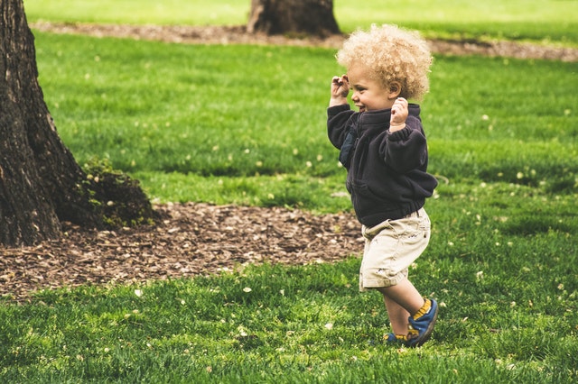 A toddler running outside, representing best toddler activities in Fort Lauderdale.