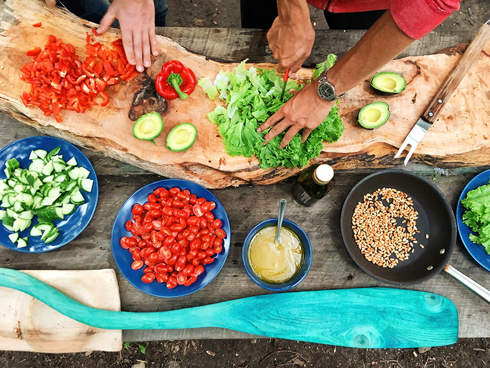 a person holding sliced vegetables