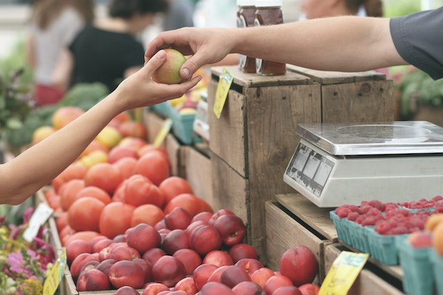 A person buying fruit at one of the best places for fresh produce in Fort Lauderdale