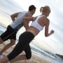 healthy couple running on the beach