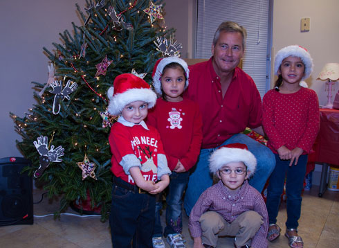 Jim Dezell with (left to right) Luiz, 3; Valentina, 3; Isabella, 4; and (front) Ernesto, 4