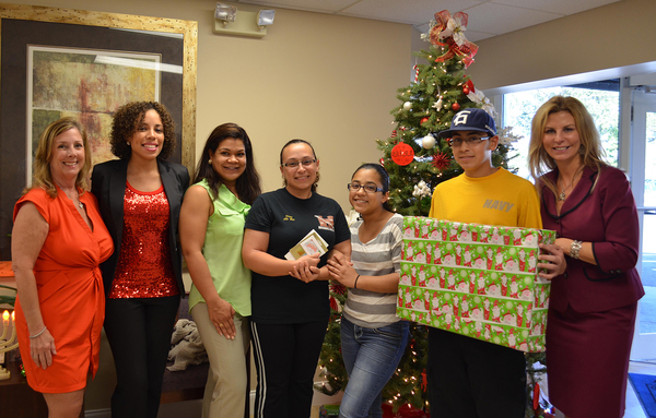 P3. Nancy Vaniman of MISSION UNITED (L) and Kathleen Cannon, President & CEO of United Way of Broward County (R) presented holiday gifts to the Trin